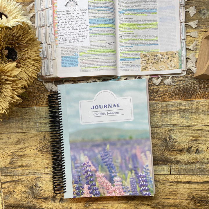 Bible study Journal with floral design on a wooden surface