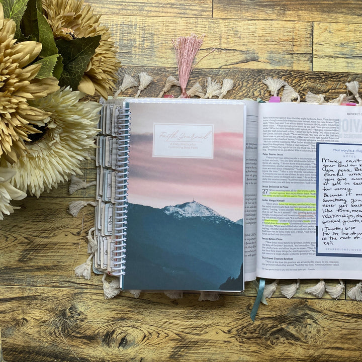 Open notebook with floral decorations on a wooden surface
