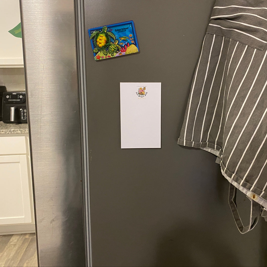 Gray refrigerator with a towel hanging on it in a kitchen setting