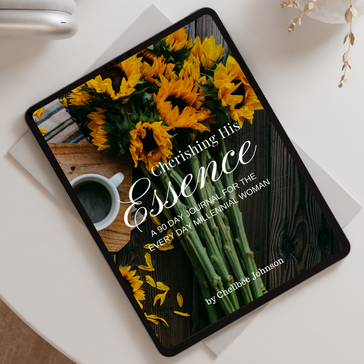 Tablet displaying a book cover with flowers and text on a white surface.